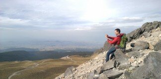 Fotógrafo en una ladera tomando una imagen