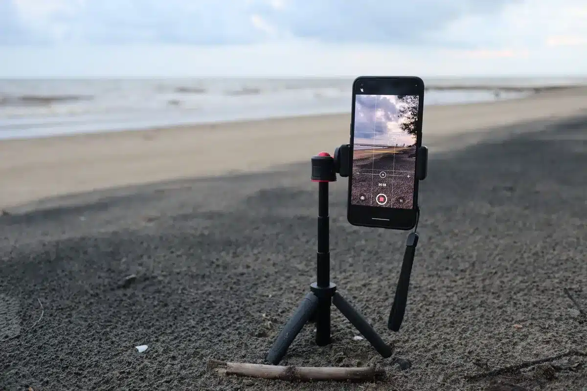 empty studio table with an unbranded smartphone on a tripod scanning a small sculpture, soft daylight, no logos