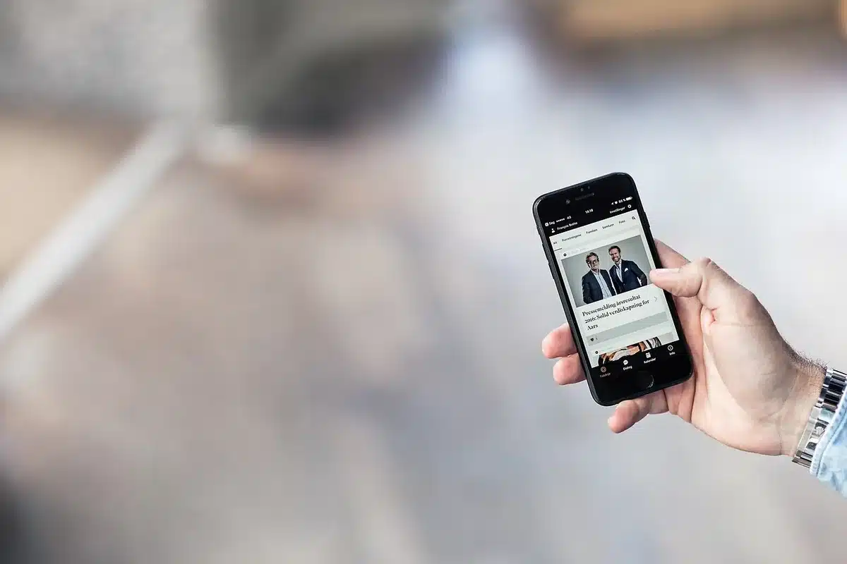 anonymous hands slowly panning an unbranded phone over a tabletop object to capture multiple angles, indoor workspace, neutral background