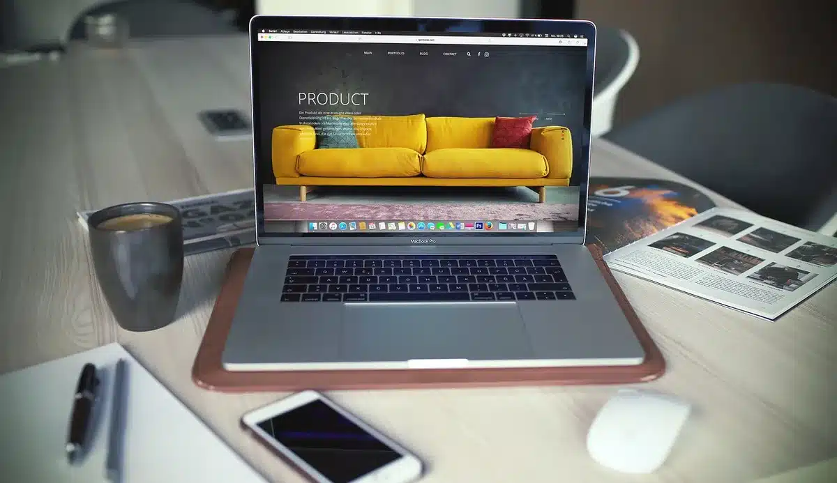 empty desk with a laptop showing an anonymous browser window and a second monitor dimmed, no logos or visible text