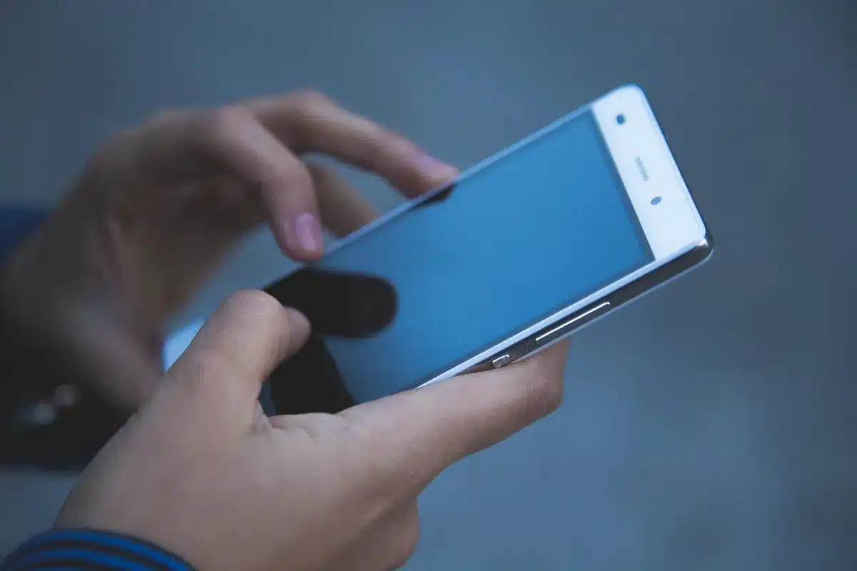 Empty smartphone on a table showing an anonymous AI chat interface silhouette