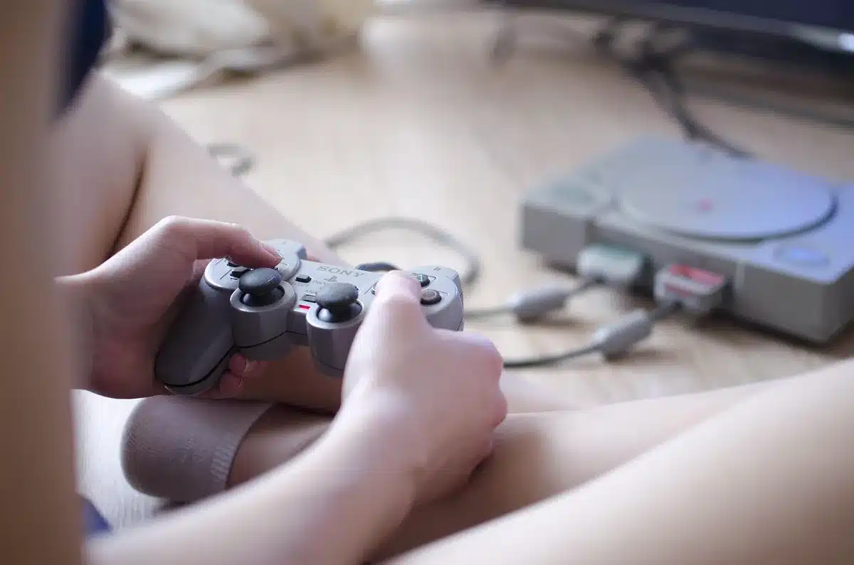 Close-up of a generic retro console controls, two analog sticks and face buttons in shallow depth of field