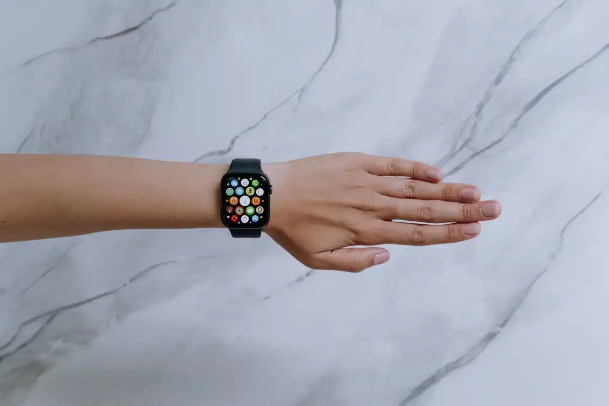 Close-up of a generic sports smartwatch on a bench, AMOLED screen glowing, no logos visible
