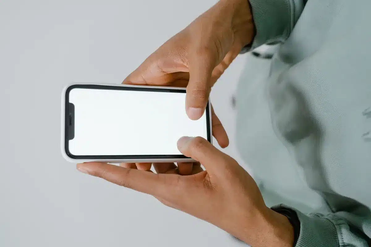 anonymous hands holding a phone with lock-screen icon dimmed