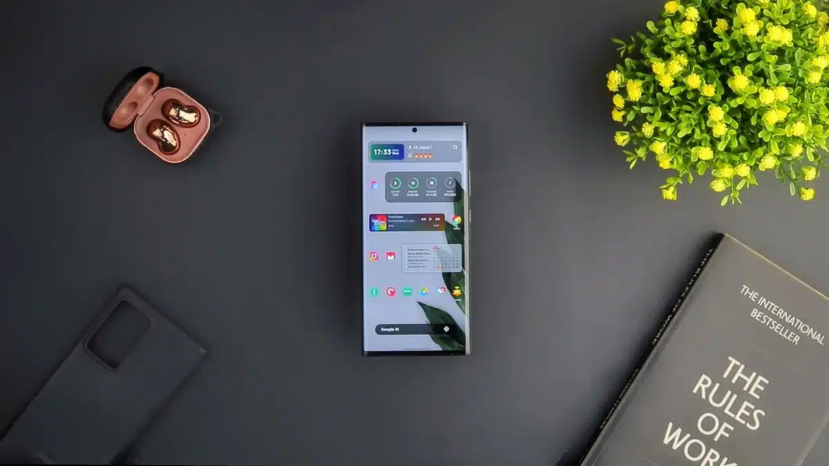 Empty foldable smartphone display with a stylus placed beside it on a wooden table, soft daylight, hint of paper-like screen texture
