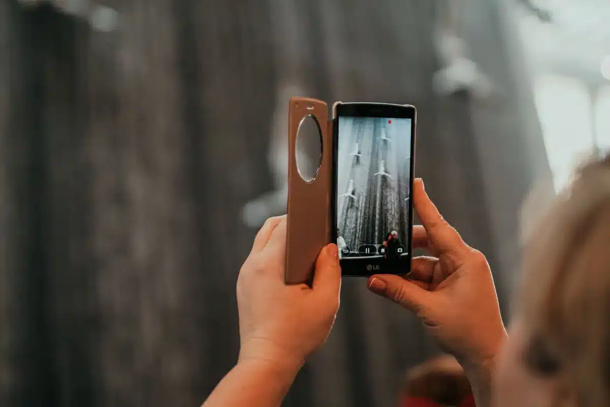 Empty staging table with a single unbranded foldable smartphone on it, soft studio light, no logos