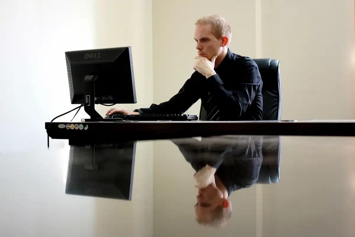 A close-up of a laptop keyboard with an anonymous video call screen reflected on the keys, no logos or faces visible