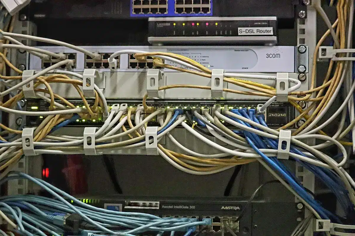 Empty server room with evenly spaced racks and glowing network cables, suggesting a neutral infrastructure hosting a protocol spec