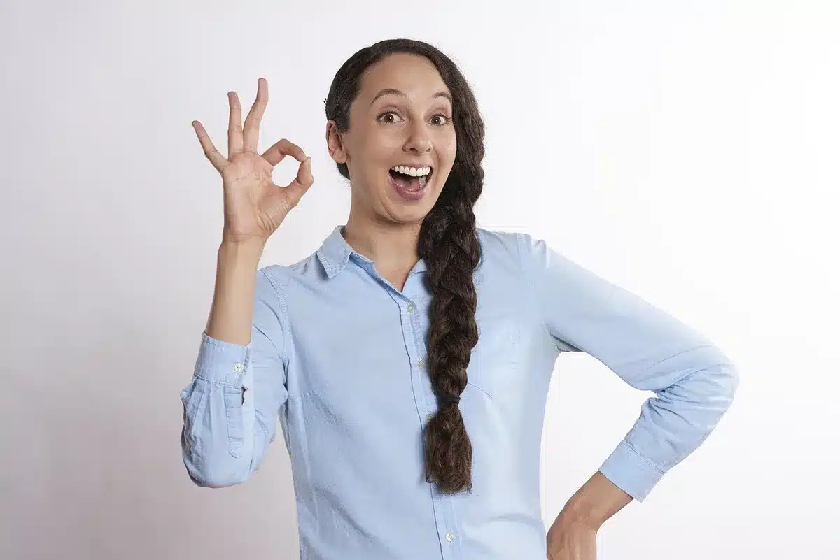 Anonymous hands of an adult approving a child's device from a second smartphone screen, visible confirmation dialog but no logos or personal data