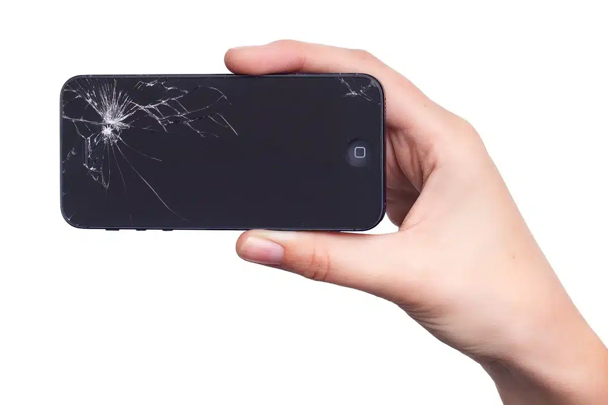Close-up of a folded generic smartphone on a repair bench, tools and a service ticket nearby, no logos or identifiable devices