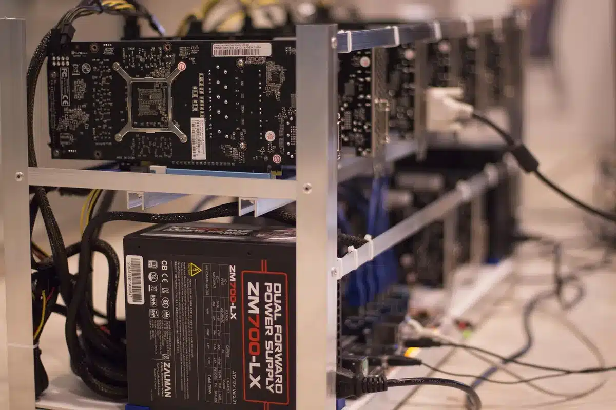 close-up of a generic high-end graphics card on a workbench, no logos, with technician hands blurred in background