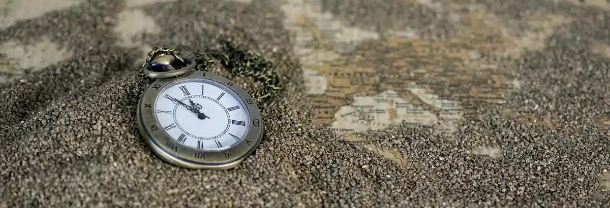 Close-up of an anonymous titanium smartwatch side view showing metal case and two physical buttons, no identifiable marks